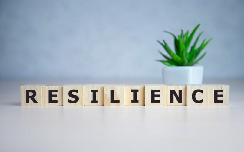 The word resilianc spelled out in blocks on a desk.
